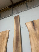 Live edge walnut wood slab with rich dark grain and natural edges.
