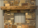 hand hewn reclaimed beam fireplace mantel mounted to stone wall
