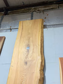 Natural cypress wood slab with rich grain patterns and live edge, perfect for custom dining tables or countertops