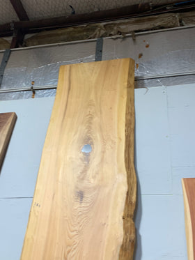 Natural cypress wood slab with rich grain patterns and live edge, perfect for custom dining tables or countertops