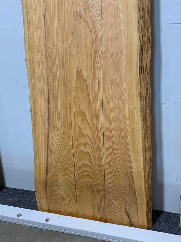 Natural cypress wood slab with rich grain patterns and live edge, perfect for custom dining tables or countertops