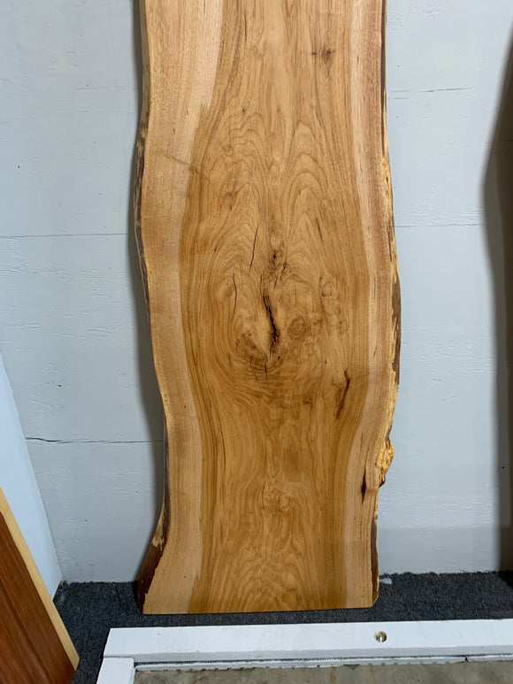 Live edge pecan slab with rich golden-brown tones, natural grain patterns, and organic edges